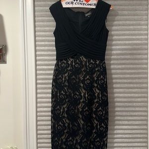 Black Adriana Papell cocktail dress featuring unique cross top and lace bottom🖤
